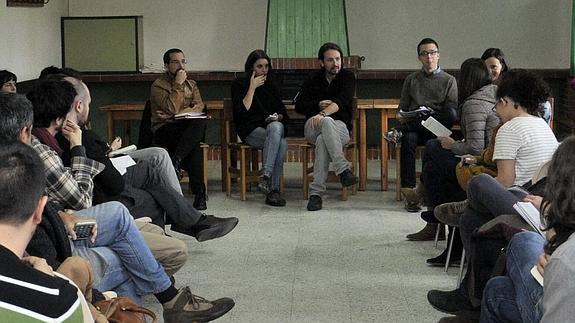 El secretario general de Podemos, Pablo Iglesias (centro), durante la reunión en el antiguo campamento de Robledo, ahora granja escuela, Efe