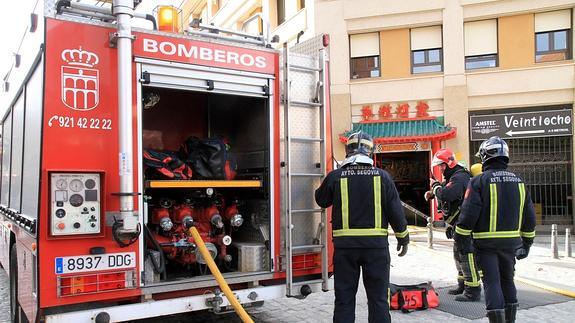 Los bomberos trabajan en el exterior una vez sofocado el fuego en el restaurante. Antonio Tanarro