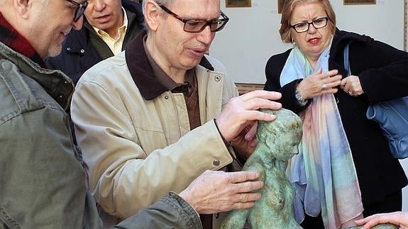 Un grupo de personas con discapacidad visual palpan una escultura de Gregorio Herrero, en la exposición instalada en la Casa de los Picos. 