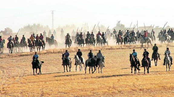 Decenas de caballistas, durante un encierro. M. Rico