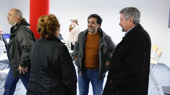 Chávez (centro) conversa con unos asistentes a la reunión informativa.