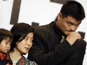 Yao Ming, junto a su esposa y su hija, durante la rueda de prensa en Shanghái. ::
CARLOS BARRIA-REUTERS