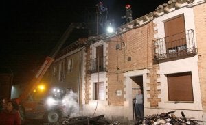 Los bomberos trabajan sobre la vivienda afectada por las llamas para apagar el fuego. ::
FOTOS DE MANUEL BRÁGIMO