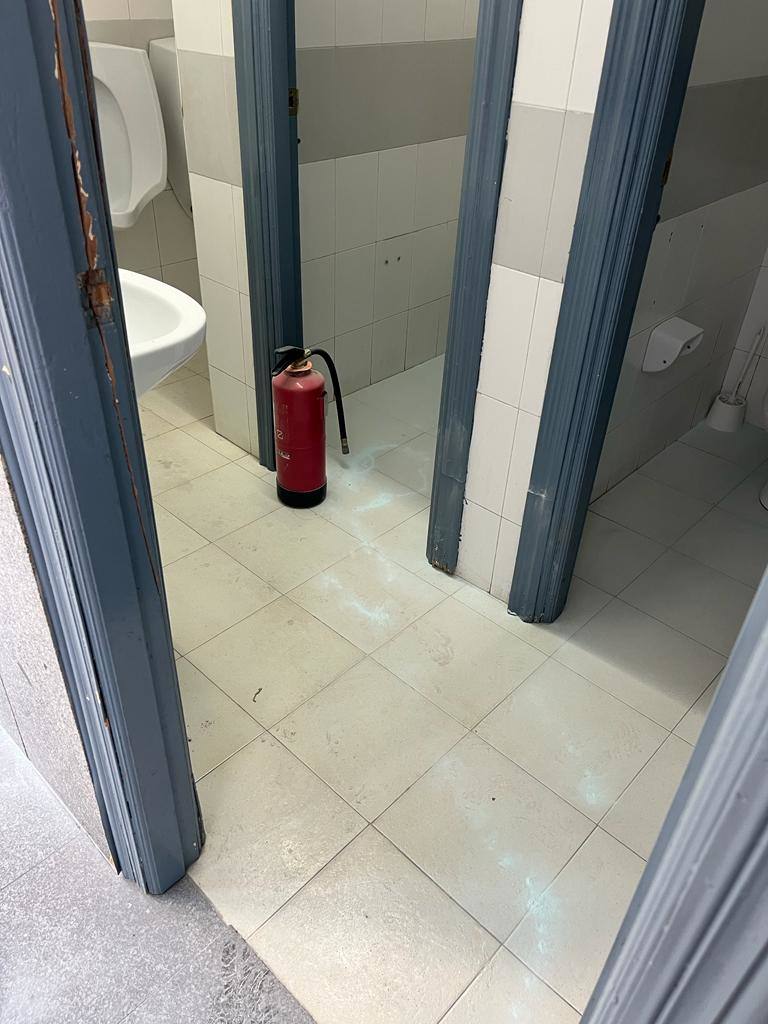 Uno de los baños de la estación de autobús, rociado con un extintor de incendios