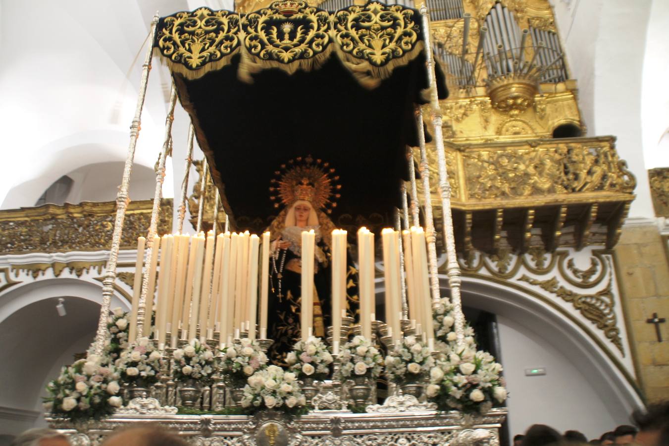 La lluvia que durante las primeras horas de la tarde se contuvo, hizo acto de presencia nada más asomarse a la calle la procesión de las túnicas celestes, que organiza la Archicofrafía del Santísimo Sacramento. Todas las emociones se vieron frustradas y el templo de San Bartolomé fue refugio para el sentimiento de quienes anhelaban acompañar esta estación de penitencia en la que se representa el momento de la institución de la Santa Cena, que junto al de Jesús ante Pilatos, fueron los únicos que realizaron su salida de la iglesia patronal. El Cristo de la Piedad, imagen impresionante en el itinerario de la Semana Santa jerezana, y la hermosa Virgen de la Paza, se quedaron dentro.Los sones de las Agruaciones y bandas que iban a acompañar este desfile sonaron especiales para bailar estas dos imágenes y servir de consuelo, mientras brotaban lágrimas en los ojos de algunos niños que encuentran en esta Cofradía su bautismo nazareno. La oración también acompañó estos momentos de tristeza al tiempo tan especiales.