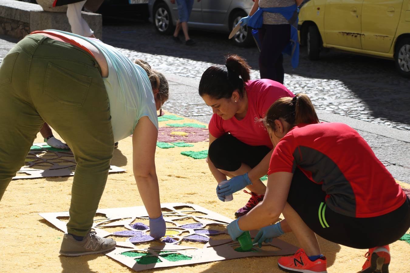 Las alfombras de sal embellecen y llenan de color, hoy, las calles de Jerez de los Caballeros con motivo de la festividad del Corpus Christi. Desde primera hora de la mañana, miembros de las cofradías y hermandades, Cáritas, grupos de catequesis, familias de los niños que han hecho este año la Primera Comunión, miembros de la Asociación de costaleros y costaleras de la Semana Santa jerezana, Ayuntamiento y vecinos han cubierto las principales calles del municipio con 6.250 kilos de sal teñida, plenas de color. A continuación, han disfrutado de una jornada de convivencia en la Casa de la Iglesia 'Cecilia de Arteaga'.