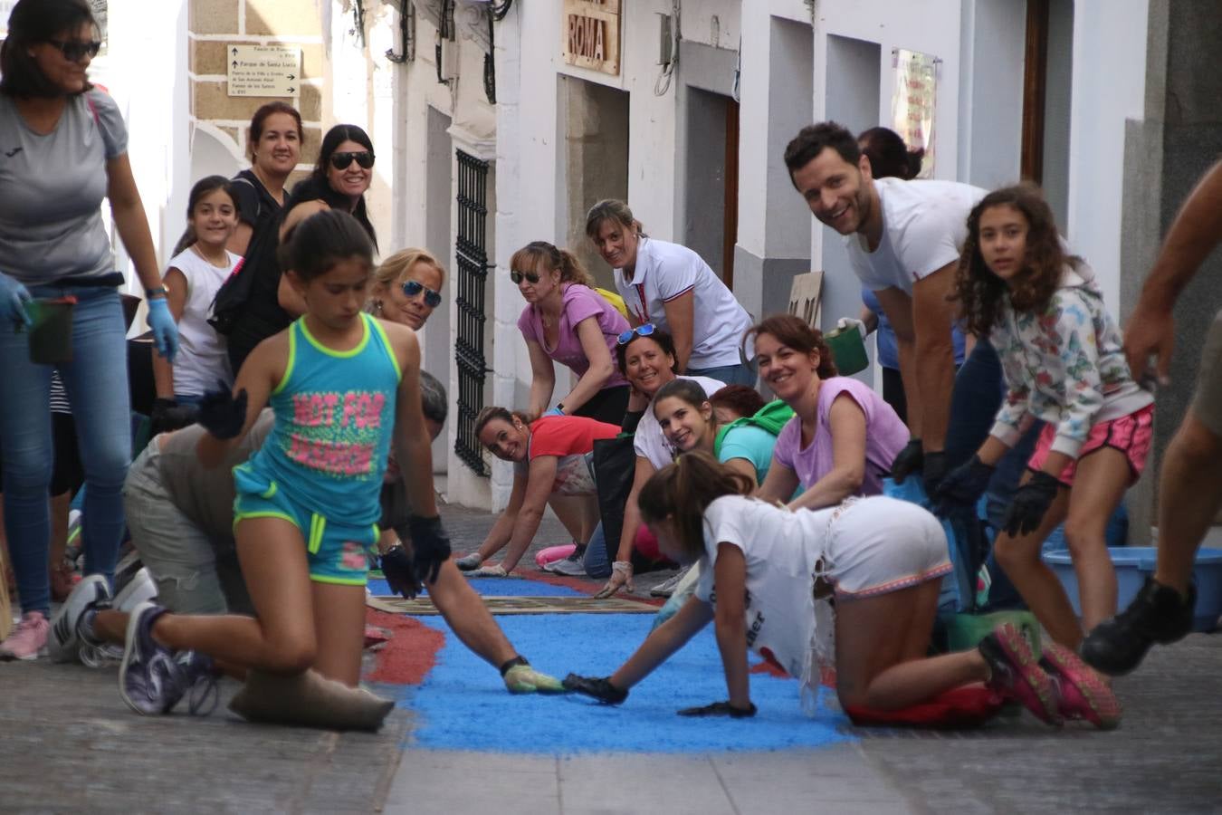 Las alfombras de sal embellecen y llenan de color, hoy, las calles de Jerez de los Caballeros con motivo de la festividad del Corpus Christi. Desde primera hora de la mañana, miembros de las cofradías y hermandades, Cáritas, grupos de catequesis, familias de los niños que han hecho este año la Primera Comunión, miembros de la Asociación de costaleros y costaleras de la Semana Santa jerezana, Ayuntamiento y vecinos han cubierto las principales calles del municipio con 6.250 kilos de sal teñida, plenas de color. A continuación, han disfrutado de una jornada de convivencia en la Casa de la Iglesia 'Cecilia de Arteaga'.