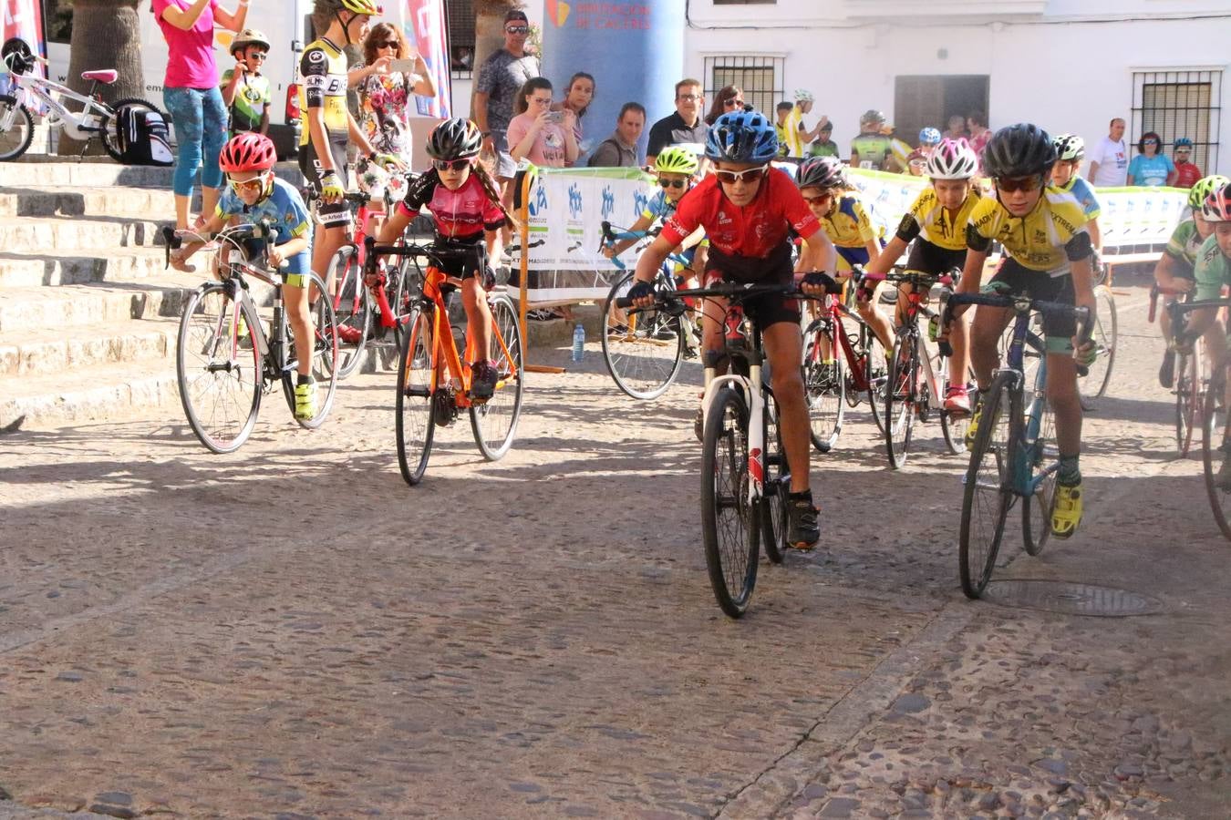 El barrio de 'Santa Catalina' de Jerez de los Caballeros ha acogido, esta mañana, la tercera prueba del Gran Premio Diputación de Badajoz 'Copa Escuelas de ciclismo en carretera', organizada por el Club Ciclista Jerez de los Caballeros y la Federación Extremeña de Ciclismo.Una competición de ciclismo que, como ya adelantó HOY Jerez, fue creada por la Federación Extremeña de Ciclismo con el objetivo de fomentar y seguir practicando deporte cuando ya han terminado todos los circuitos que se celebran durante el curso académico. En la citada prueba, han participado diferentes categorías: cadete, promesa, junior, principiante, alevín e infantil.Juan Luis Soriano, presidente del Club Ciclista Jerez, ha manifestado su satisfacción por el buen desarrollo de la jornada, «este tipo de pruebas son fundamentales para hacer cantera y promover este deporte entre los más pequeños».