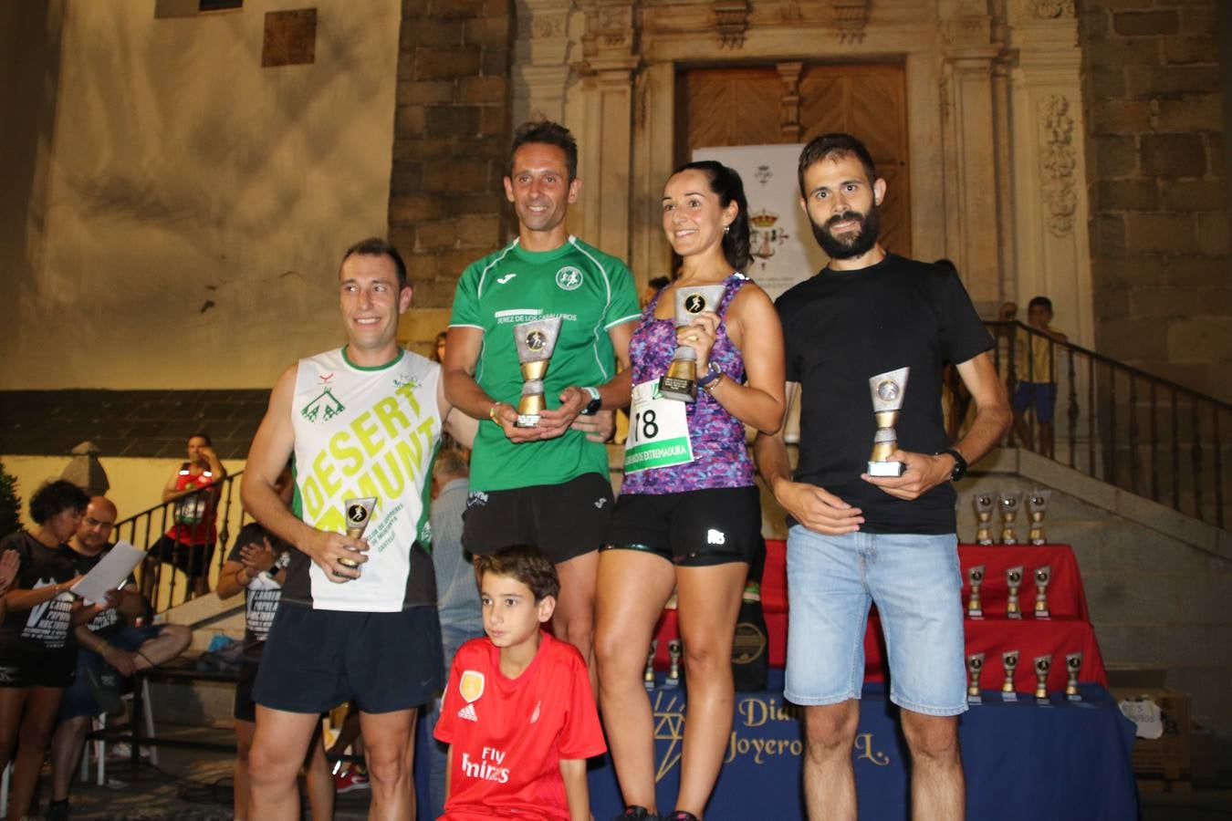 La Plaza de España de Jerez de los Caballeros acogió, ayer, la V Carrera Popular Nocturna 'Recorriendo el Medievo', organizada por el Ayuntamiento del municipio con la colaboración del Plan de Dinamización Deportiva de la Mancomunidad Sierra Suroeste. Las principales calles del municipio volvieron a convertirse en el mejor escenario para el desarrollo de esta prueba deportiva que, año tras año, se consolida como una de las citas más destacadas del calendario estival jerezano y en la que la solidaridad, también, está muy presente. Así, se lograron recaudar 153 kilos y 22 euros que irán destinados al almacén de alimentos que gestiona la Asamblea local de Cruz Roja en el municipio.En esta edición, han participado unos 200 corredores de la localidad y alrededores, siendo Manuel Gómez Lucas y Tina María Ramos, vencedores de la clasificación general.