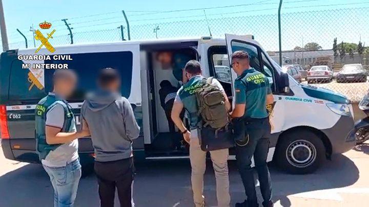Los detenidos son introducidos en el furgón de la Guardia Civil 