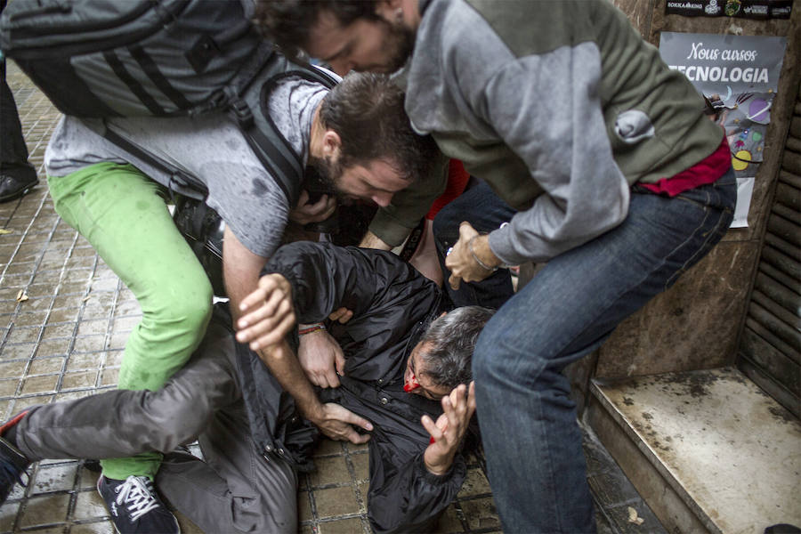 Dos personas asisten a un manifestante herido.