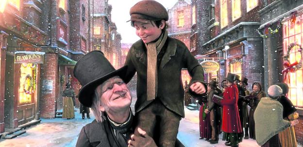 Un Scrooge reconciliado con la Navidad pasea en brazos al hijo tullido de su empleado, en la versión del célebre libro de Dickens (abajo) que Robert Zemeckis llevó al cine. disney