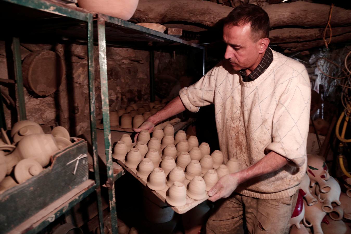 El palestino Jamal Fakhori y su hijo hacen vasijas de arcilla en su taller en la ciudad de Jaba, cerca de Jenin, en la ocupada Cisjordania