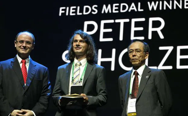 Fotografía cedida de la Agencia Brasil del profesor de la Universidad de Bonn en Alemania Peter Scholze (c) mientras recibe la medalla Fields durante la ceremonia de entrega. 