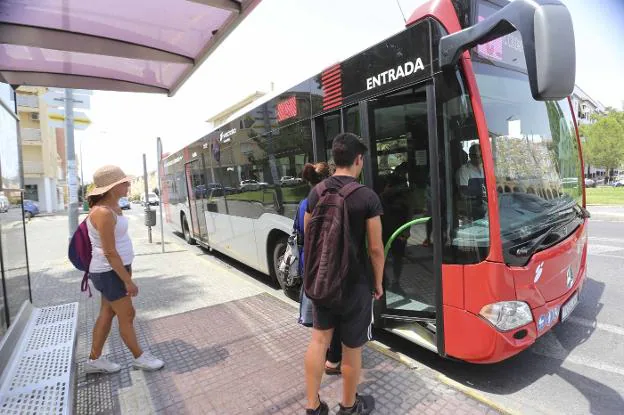 Varias personas esperan para montarse en un autobús urbano de Mérida. :: j. m. romero