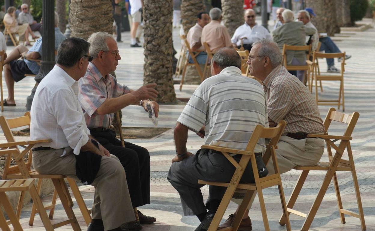 Varios jubilados conversan en una explanada.