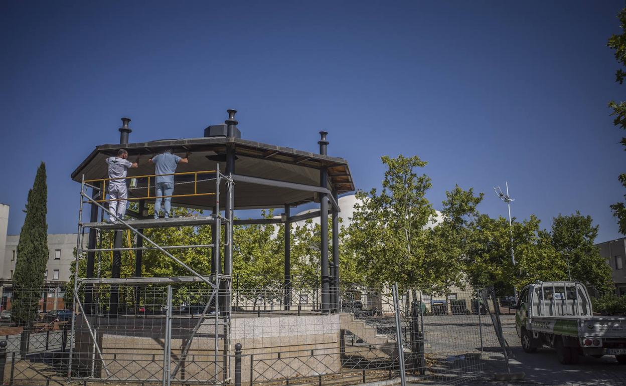 Dos trabajadores dedicados a la rehabilitación del templete. 