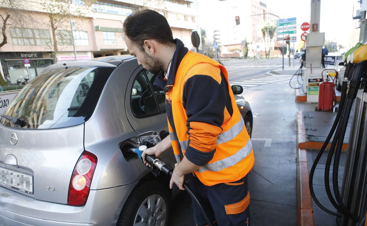 Un trabajador de una estación de servicio de Cáceres echando gasolina a un vehículo. 