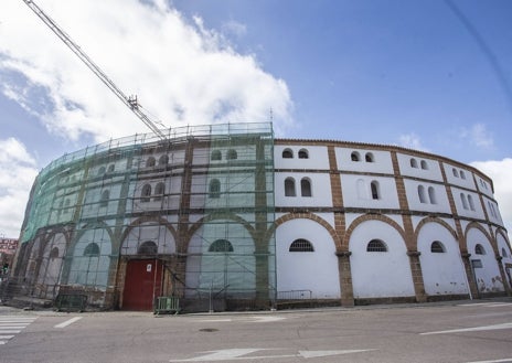 Imagen secundaria 1 - Desarrollo de los trabajos en la Era de los Mártires en las fotografías superior e inferior, con la retirada de la grúa. En el centro una imagen del exterior de la Plaza Mayor cacereña, con los andamios.