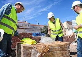 La consejera Leire Iglesias, en las obras de Ribera del Fresno, junto a un palé de ladrillos de tierra comprimida.