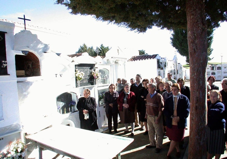 Rezando ante el nicho del cementerio en donde se colocaron los restos de los dos desconocidos.