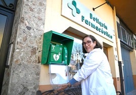 La farmacéutica Pilar Jiménez muestra el desfibrilador en el botiquín de Baños de Montemayor.