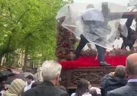 La lluvia sorprende a la cofradía de los Estudiantes en su procesión del Viernes Santo en Cáceres