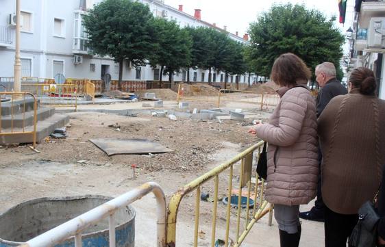 Vecinos contemplan tras las vallas como han quedado las obras.