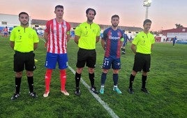 Los dos capitanes con el trío arbitral, antes de iniciar el choque.