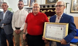 Francisco Bellido posa con la credencial de pregonero junto con los responsables de la Agrupación.