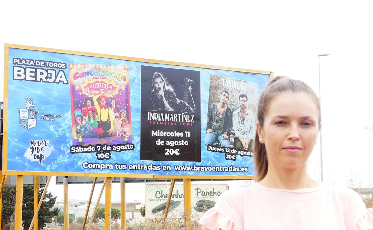 María Herminia Padial delante de un cartel de conciertos del municipio de Berja. 
