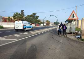 Imagen de niños acudiendo al colegio de Pampanico, teniendo que andar por la calzada.