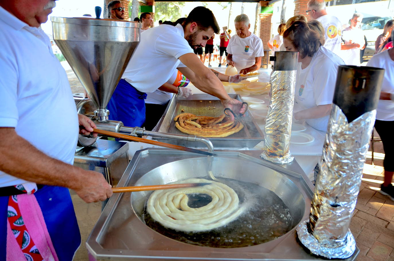 Desayuno popular, con churros, chocolate y la Charanga Vaso Largo, en el Parque de los Pinos de Huétor Vega.