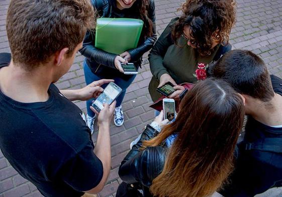 Un grupo de adolescentes, pendientes de las redes.