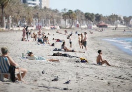 Varios bañistas disfrutan de una jornada en la playa.