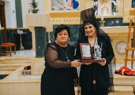 La pregonera, Begoña García, recibe un obsequio en la Iglesia de Nuestra Señora del Rosario de Roquetas.