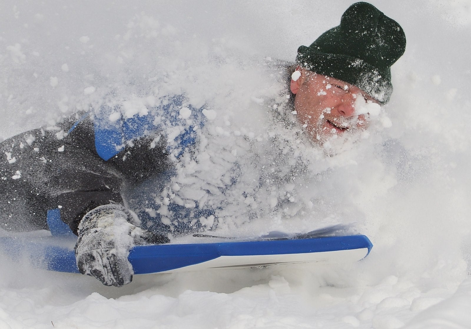 Un hombre se desliza por una colina cubierta de nieve en el noroeste de Washington, DC.