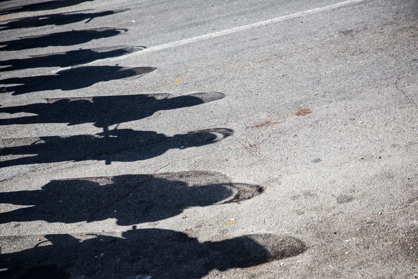 Las sombras de la policía estatal de Maryland que estaban de guardia se ven en el suelo cerca de una farmacia CVS que fue destruida ayer durante los disturbios tras el funeral de Freddie Gray en Baltimore, Maryland.
