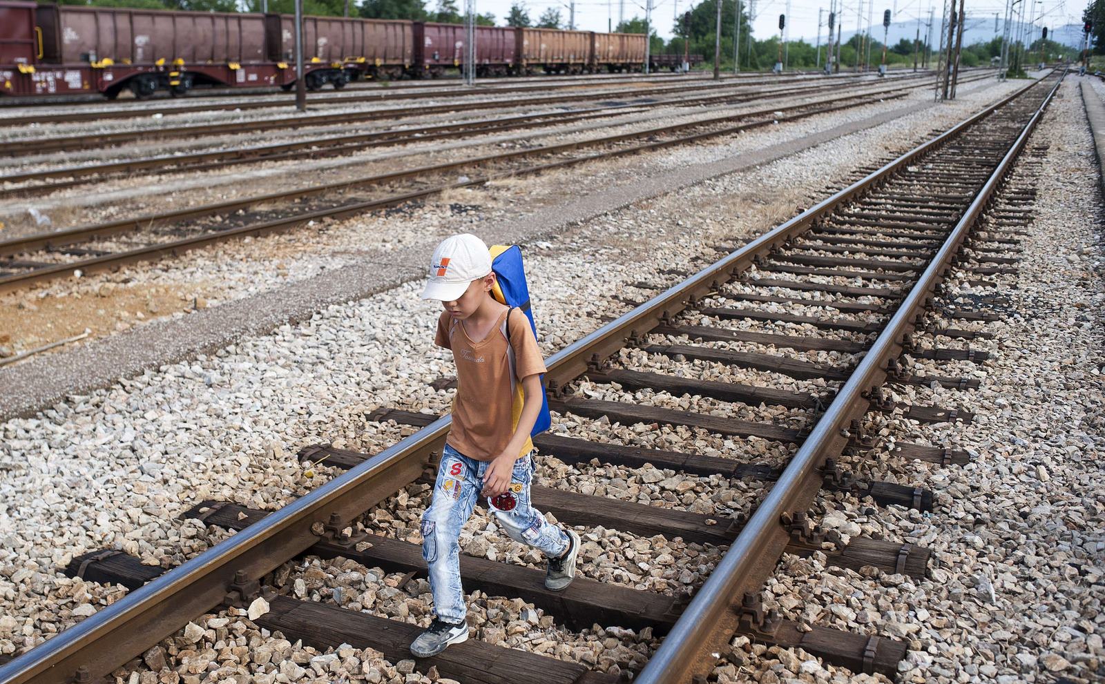 Un niño camina sobre las vías del tren hacia la ciudad de Gevgelija en la frontera entre Macedonia griega, tratando de coger un tren a Serbia y los países del norte de Europa.