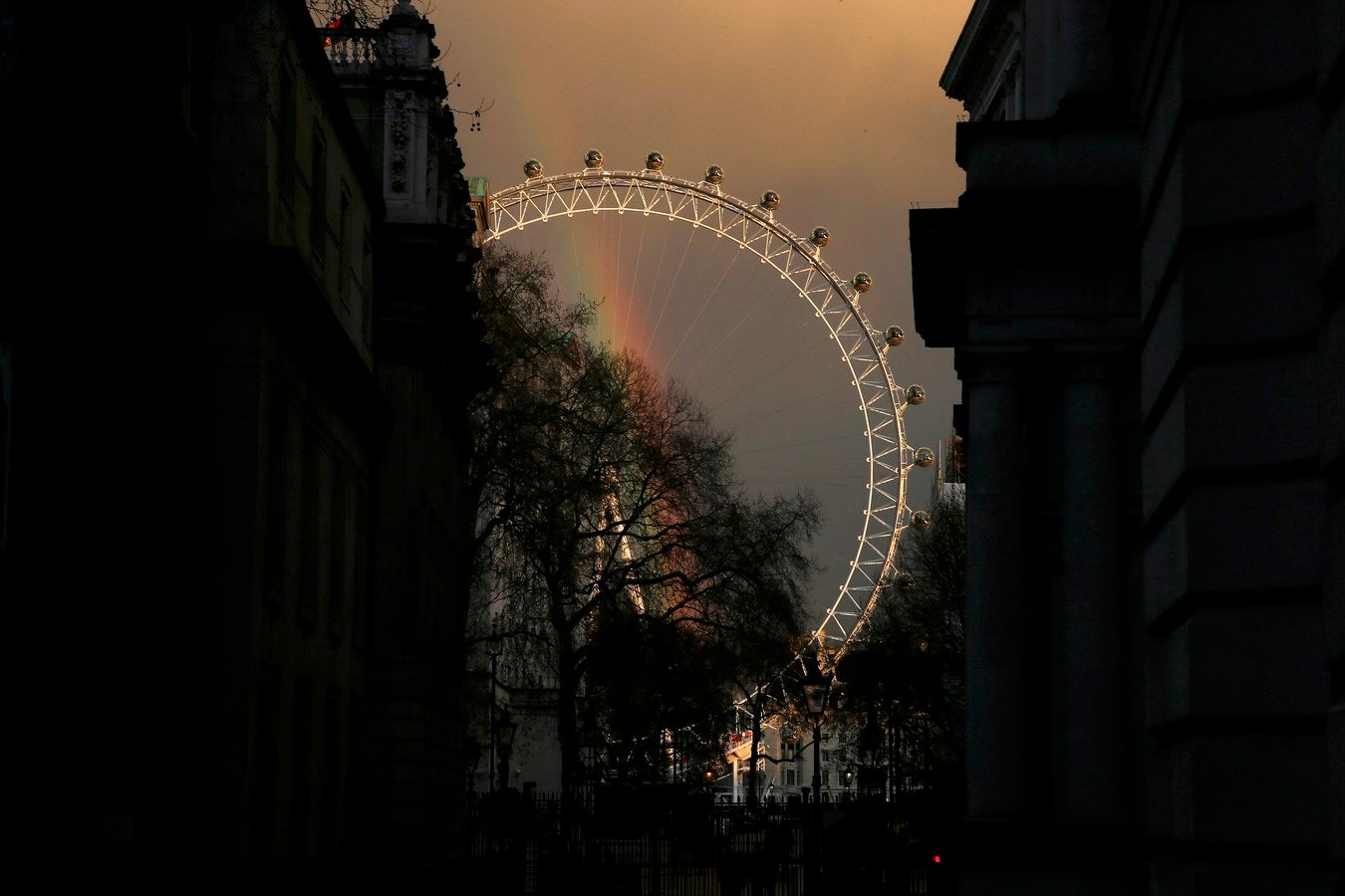 Un arco iris se ve a través del ojo de Londres en el centro de Londres, Reino Unido.