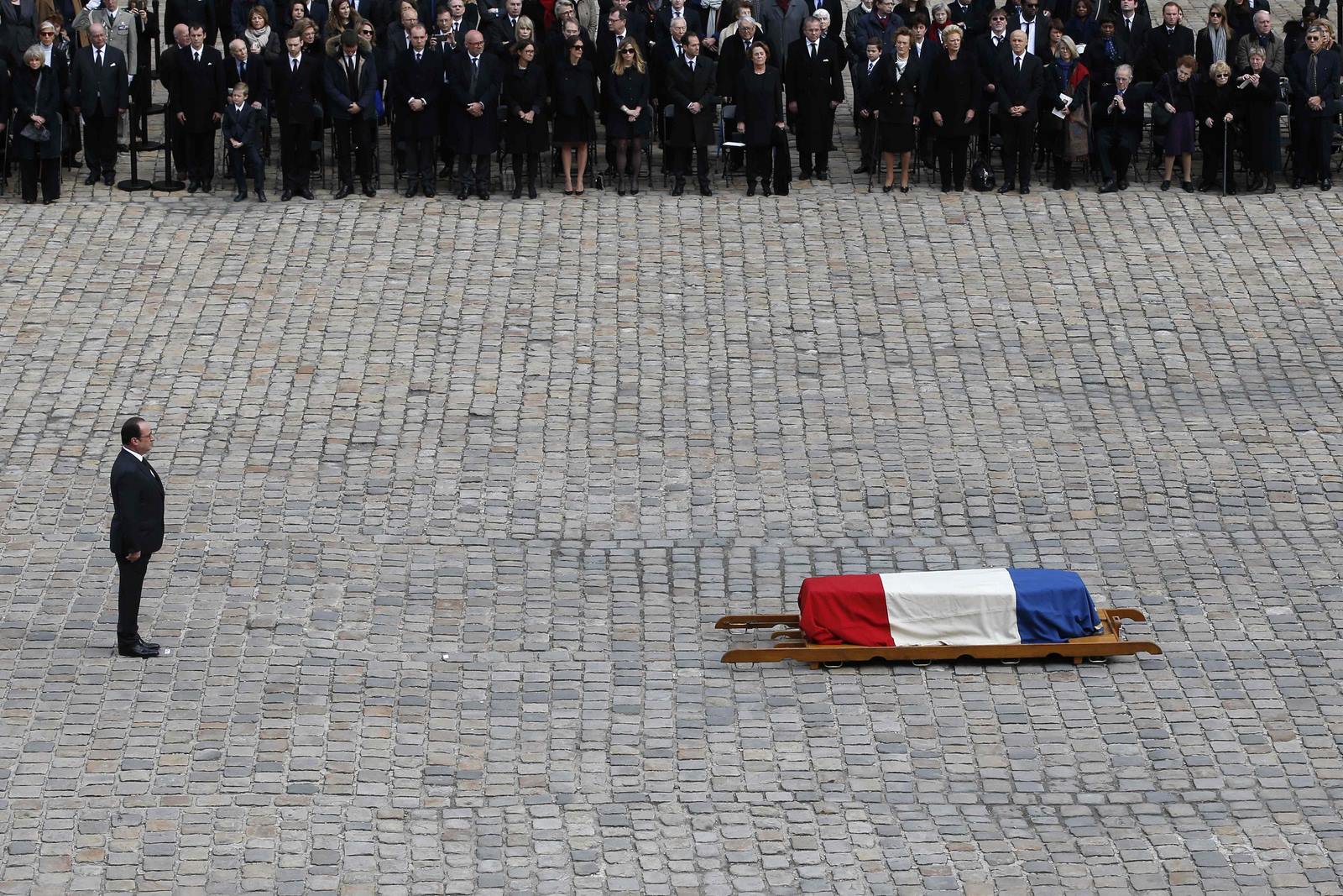 El presidente francés, Francois Hollande, junto al ataúd cubierto por la bandera de la escritora francesa y académico Alain Decaux durante su funeral en Les Invalides en París.
