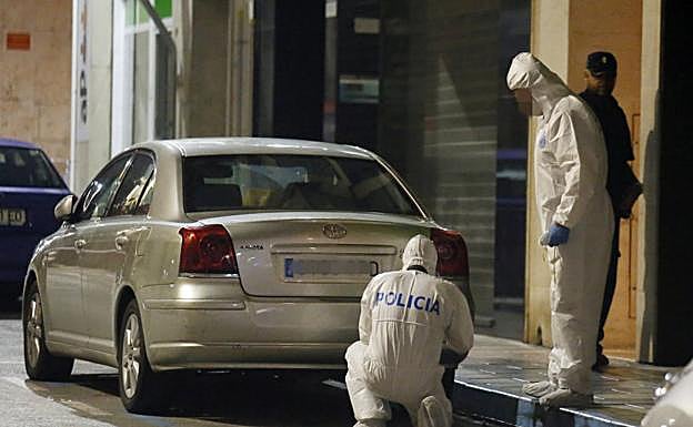 Agentes de la Policía Científica inspeccionan las inmediaciones de la vivienda en Elda