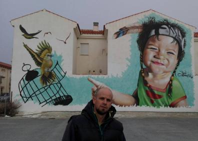 Imagen secundaria 1 - 1. Badi Coloreando ante uno de sus murales, en Ventas de Huelma. / 2. Un surtido de botes de colores.