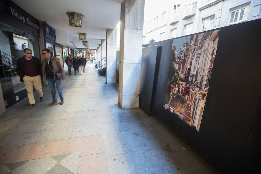 El Ayuntamiento inaugura una muestra de carteles con las fotos de Semana Santa de 2017 para embellecer la céntrica calle 'tapando' la parte trasera de las gradas de la carrera oficial.