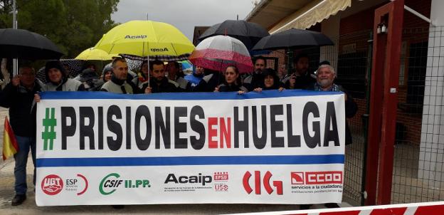 Trabajadores concentrados ayer bajo la lluvia a la entrada de la prisión. 