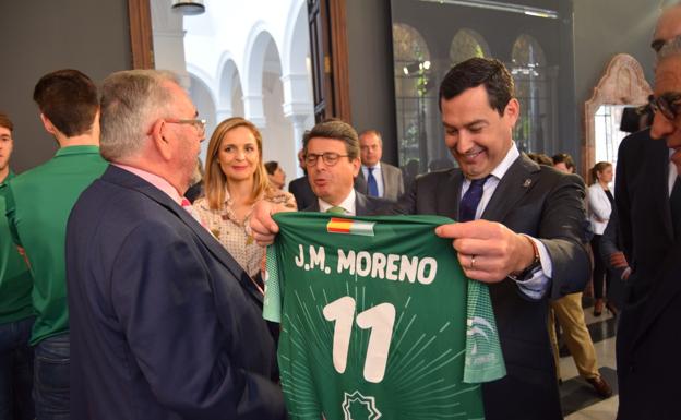 Juanama Moreno Bonilla observa la camiseta con la que le ha obsequiado el Unicaja Almería.