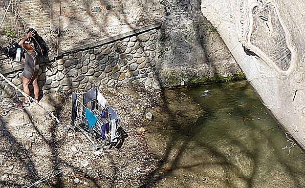 Una mujer hace la colada en el cauce junto a las Chirimías 