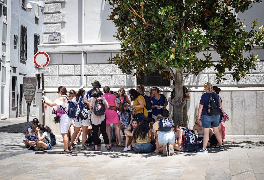 Granadinos y visitantes se las apañan en las calles para no sufrir mucho el enorme calor de estos días