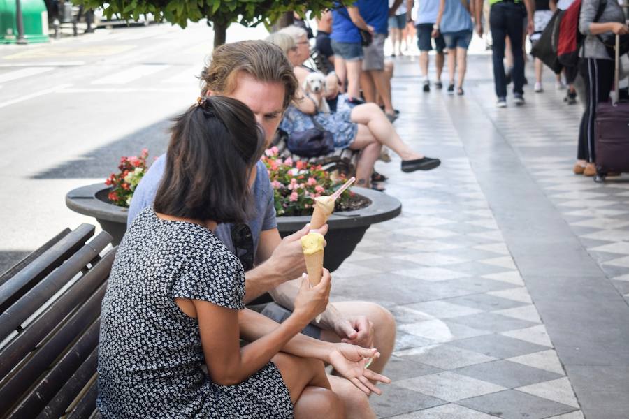Granadinos y visitantes se las apañan en las calles para no sufrir mucho el enorme calor de estos días