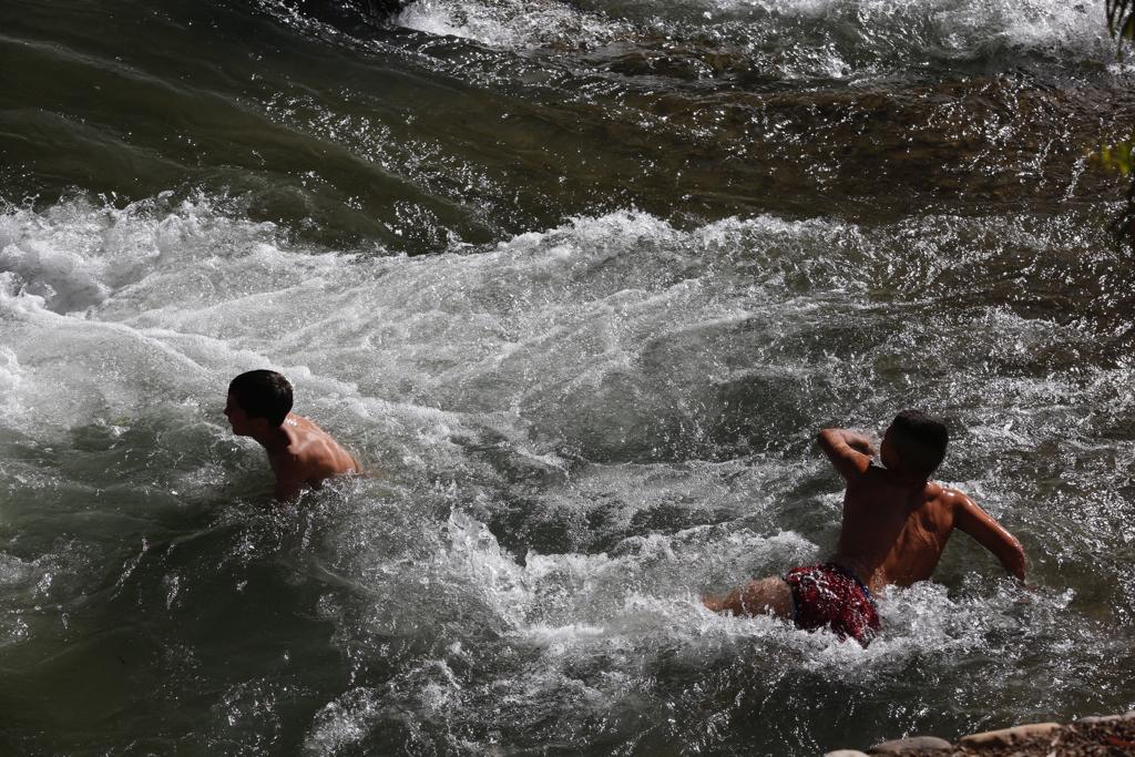 Granadinos y visitantes se las apañan en las calles para no sufrir mucho el enorme calor de estos días
